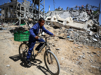 A Palestinian boy is walking past a destroyed mosque in the city of Nuseirat in the central Gaza Strip on April 21, 2024, amid ongoing battl...