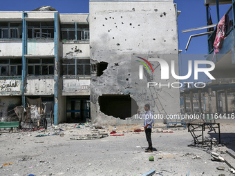 An UNRWA-run school is lying in ruins during the ongoing conflict between Israel and the Palestinian Islamist group Hamas, in Nuseirat, cent...