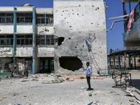 An UNRWA-run school is lying in ruins during the ongoing conflict between Israel and the Palestinian Islamist group Hamas, in Nuseirat, cent...