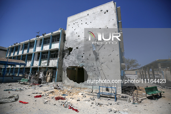 An UNRWA-run school is lying in ruins following its destruction during Israel's military offensive, amid the ongoing conflict between Israel...