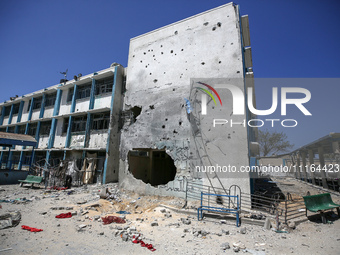 An UNRWA-run school is lying in ruins following its destruction during Israel's military offensive, amid the ongoing conflict between Israel...