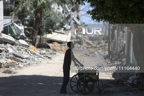 A Palestinian boy is standing past a destroyed mosque in the city of Nuseirat in the central Gaza Strip on April 21, 2024, amid ongoing batt...