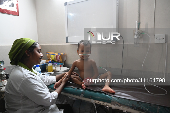 A child is receiving medical treatment for pneumonia at Dhaka Child Hospital amid an ongoing heatwave in Dhaka, Bangladesh, on April 21, 202...