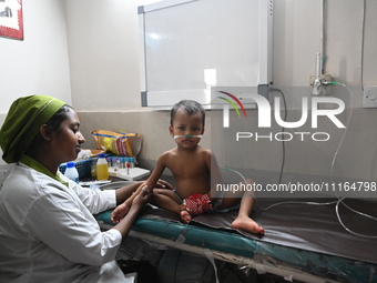 A child is receiving medical treatment for pneumonia at Dhaka Child Hospital amid an ongoing heatwave in Dhaka, Bangladesh, on April 21, 202...