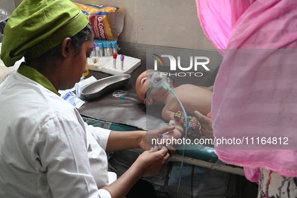 A child is receiving medical treatment for pneumonia at Dhaka Child Hospital amid an ongoing heatwave in Dhaka, Bangladesh, on April 21, 202...