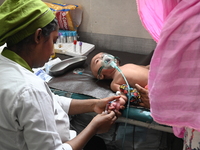 A child is receiving medical treatment for pneumonia at Dhaka Child Hospital amid an ongoing heatwave in Dhaka, Bangladesh, on April 21, 202...