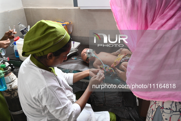 A child is receiving medical treatment for pneumonia at Dhaka Child Hospital amid an ongoing heatwave in Dhaka, Bangladesh, on April 21, 202...