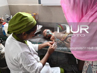 A child is receiving medical treatment for pneumonia at Dhaka Child Hospital amid an ongoing heatwave in Dhaka, Bangladesh, on April 21, 202...