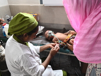 A child is receiving medical treatment for pneumonia at Dhaka Child Hospital amid an ongoing heatwave in Dhaka, Bangladesh, on April 21, 202...