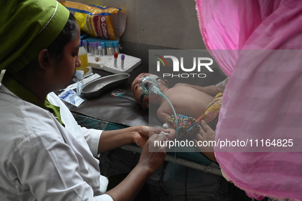 A child is receiving medical treatment for pneumonia at Dhaka Child Hospital amid an ongoing heatwave in Dhaka, Bangladesh, on April 21, 202...