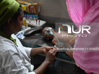 A child is receiving medical treatment for pneumonia at Dhaka Child Hospital amid an ongoing heatwave in Dhaka, Bangladesh, on April 21, 202...