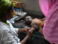 A child is receiving medical treatment for pneumonia at Dhaka Child Hospital amid an ongoing heatwave in Dhaka, Bangladesh, on April 21, 202...