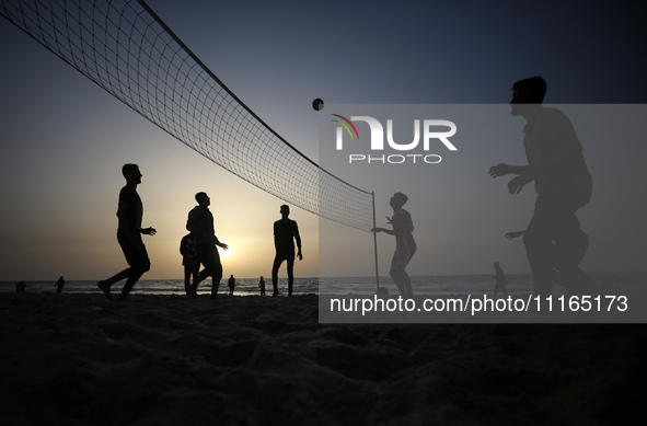 Palestinians are enjoying the beach on a hot day amid the ongoing conflict between Israel and Hamas in Deir Al-Balah, in the central Gaza St...