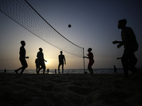 Palestinians are enjoying the beach on a hot day amid the ongoing conflict between Israel and Hamas in Deir Al-Balah, in the central Gaza St...