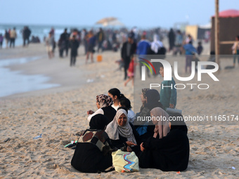 Palestinians are enjoying the beach on a hot day amid the ongoing conflict between Israel and Hamas in Deir Al-Balah, in the central Gaza St...