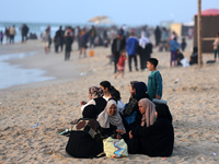 Palestinians are enjoying the beach on a hot day amid the ongoing conflict between Israel and Hamas in Deir Al-Balah, in the central Gaza St...