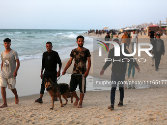 Palestinians are enjoying the beach on a hot day amid the ongoing conflict between Israel and Hamas in Deir Al-Balah, in the central Gaza St...