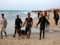 Palestinians are enjoying the beach on a hot day amid the ongoing conflict between Israel and Hamas in Deir Al-Balah, in the central Gaza St...