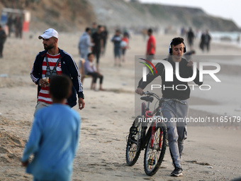 Palestinians are enjoying the beach on a hot day amid the ongoing conflict between Israel and Hamas in Deir Al-Balah, in the central Gaza St...