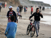 Palestinians are enjoying the beach on a hot day amid the ongoing conflict between Israel and Hamas in Deir Al-Balah, in the central Gaza St...