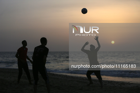 Palestinians are enjoying the beach on a hot day amid the ongoing conflict between Israel and Hamas in Deir Al-Balah, in the central Gaza St...