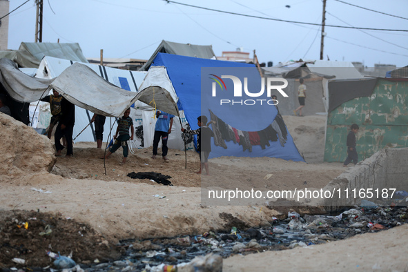 Palestinians are enjoying the beach on a hot day amid the ongoing conflict between Israel and Hamas in Deir Al-Balah, in the central Gaza St...