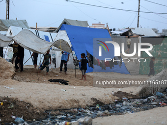 Palestinians are enjoying the beach on a hot day amid the ongoing conflict between Israel and Hamas in Deir Al-Balah, in the central Gaza St...