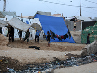 Palestinians are enjoying the beach on a hot day amid the ongoing conflict between Israel and Hamas in Deir Al-Balah, in the central Gaza St...