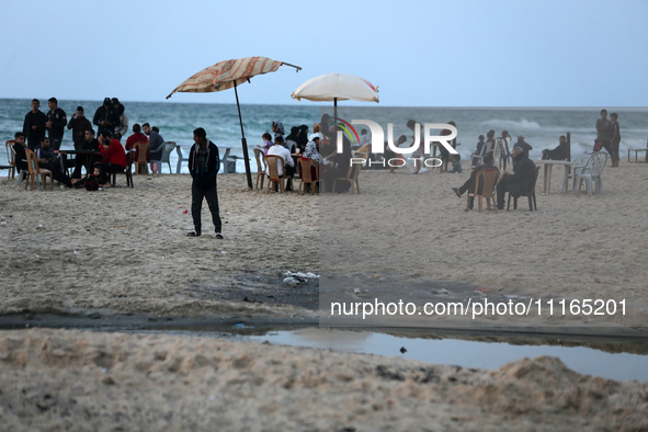 Palestinians are enjoying the beach on a hot day amid the ongoing conflict between Israel and Hamas in Deir Al-Balah, in the central Gaza St...