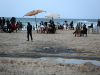 Palestinians are enjoying the beach on a hot day amid the ongoing conflict between Israel and Hamas in Deir Al-Balah, in the central Gaza St...