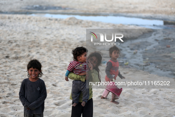 Palestinians are enjoying the beach on a hot day amid the ongoing conflict between Israel and Hamas in Deir Al-Balah, in the central Gaza St...