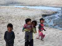 Palestinians are enjoying the beach on a hot day amid the ongoing conflict between Israel and Hamas in Deir Al-Balah, in the central Gaza St...