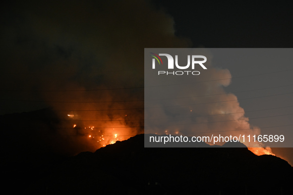 Smoke is billowing from a fire that has broken out at the Ghazipur landfill site on the outskirts of New Delhi, India, on April 21, 2024. 