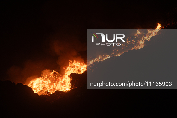 Smoke is billowing from a fire that has broken out at the Ghazipur landfill site on the outskirts of New Delhi, India, on April 21, 2024. 