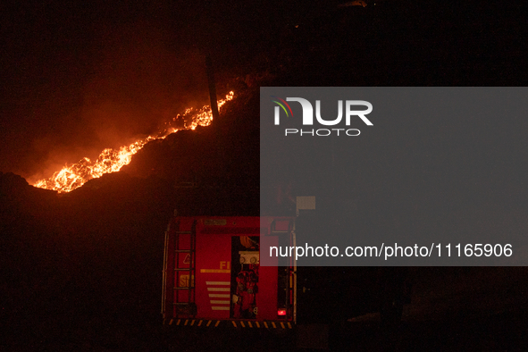 A Fire Brigade van is entering the Ghazipur landfill site while smoke is billowing from a fire that has broken out on the outskirts of New D...