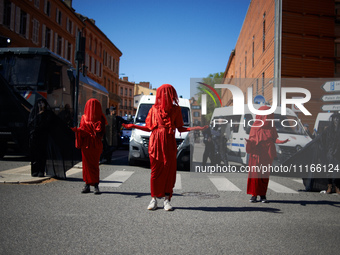 Red Rebels from Extinction Rebellion are standing in front of riot police in Toulouse, France, on April 21, 2024. Several thousand people ar...