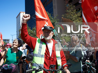 A cyclist from Castres is raising his fist while arriving at the protest in Toulouse, France, on April 21, 2024. Several thousand people are...