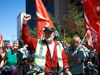 A cyclist from Castres is raising his fist while arriving at the protest in Toulouse, France, on April 21, 2024. Several thousand people are...