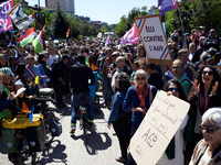 People are welcoming a cyclist arriving from Castres. The placard on the right is reading 'Elected people against the A69'. Several thousand...