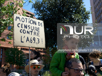 Protesters are holding placards expressing a vote of no confidence against the A69 as several thousand people demonstrate in the streets of...