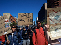 People are holding cardboard signs that read 'Delga Stop to the damages' and 'ZAD everywhere', where ZAD stands for Zone To Defend. Several...