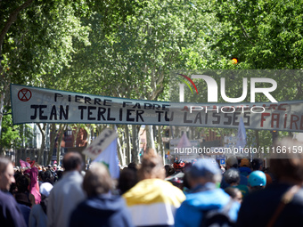 Protesters are marching in the streets of Toulouse, France, on April 21, 2024, displaying a banner that reads 'Pierre Fabre shareholder, Jea...