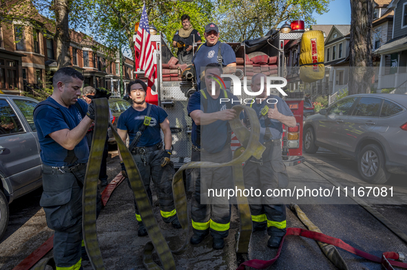 The Chicago Fire Department and Chicago Police Department respond to a structure fire at 1921 West Newport Avenue, in Chicago, IL, in the Ro...