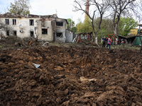 A crater from the debris of a Russian missile is being seen in a residential area in the Odesa Region, Southern Ukraine, on April 21, 2024....