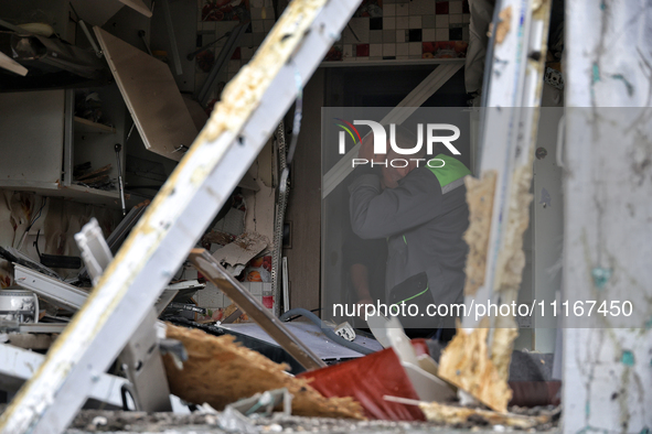 A man is pressing his hand to his forehead in a kitchen that has been damaged by a Russian missile attack in the Odesa region, southern Ukra...