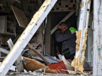 A man is pressing his hand to his forehead in a kitchen that has been damaged by a Russian missile attack in the Odesa region, southern Ukra...