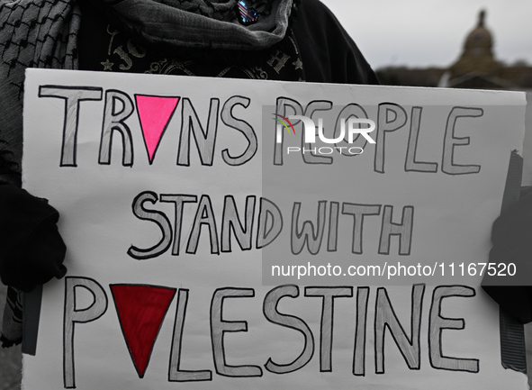 EDMONTON, CANADA - APRIL 21:
An activist holds a placard with words 'Trans People Stand With Palestine' as members of the Palestinian diaspo...