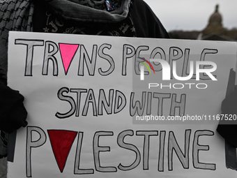 EDMONTON, CANADA - APRIL 21:
An activist holds a placard with words 'Trans People Stand With Palestine' as members of the Palestinian diaspo...