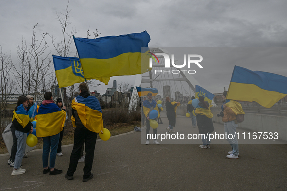 EDMONTON, CANADA - APRIL 21, 2024:
Members of the Ukrainian diaspora proudly wave national flags, hold blue and yellow balloons, and display...