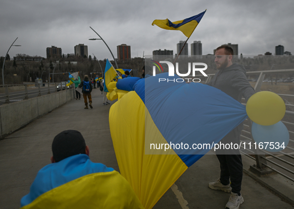 EDMONTON, CANADA - APRIL 21, 2024:
Members of the Ukrainian diaspora proudly wave national flags, hold blue and yellow balloons, and display...